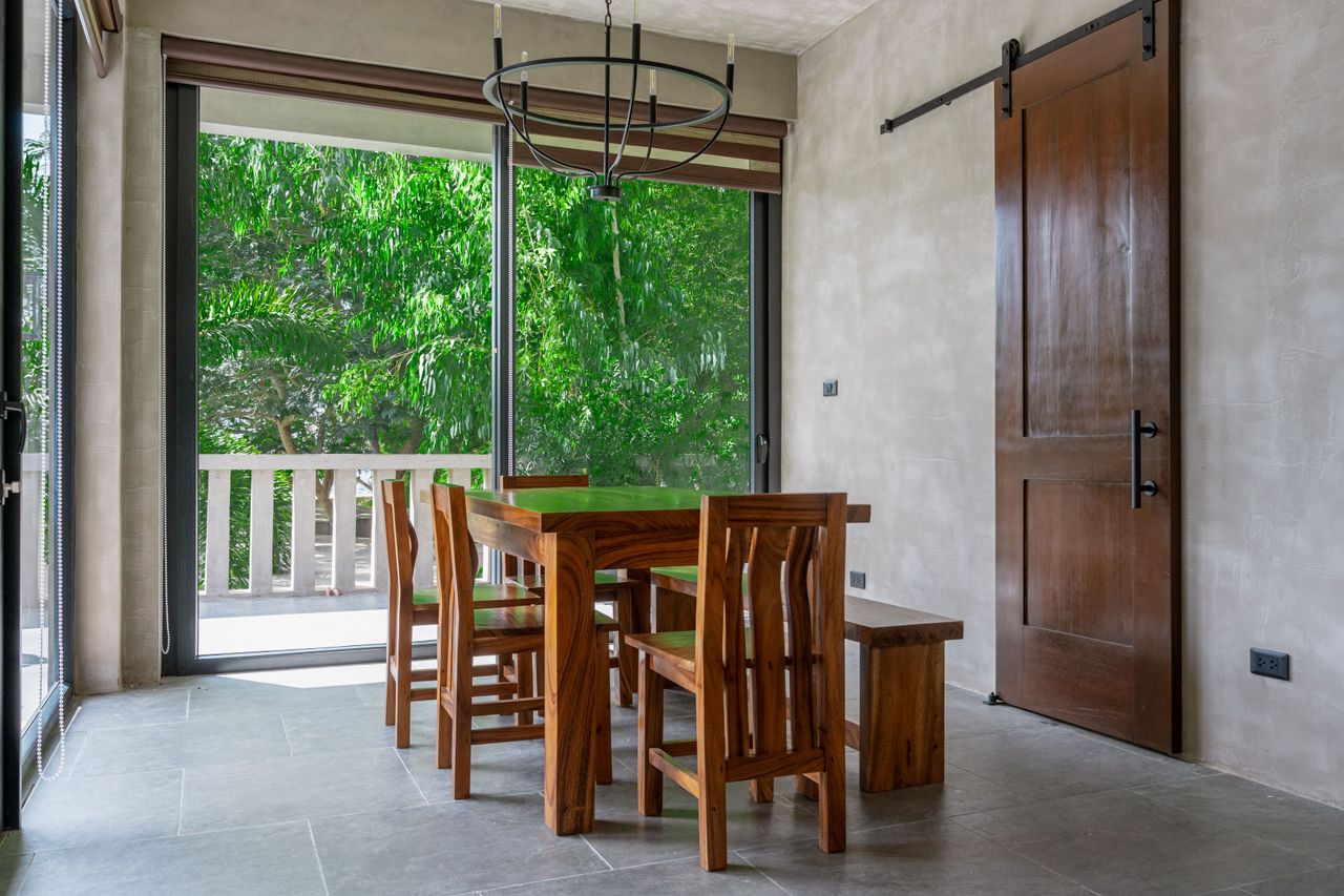 A solid hardwood dining table, bench, and barn door in a Horizon cabin