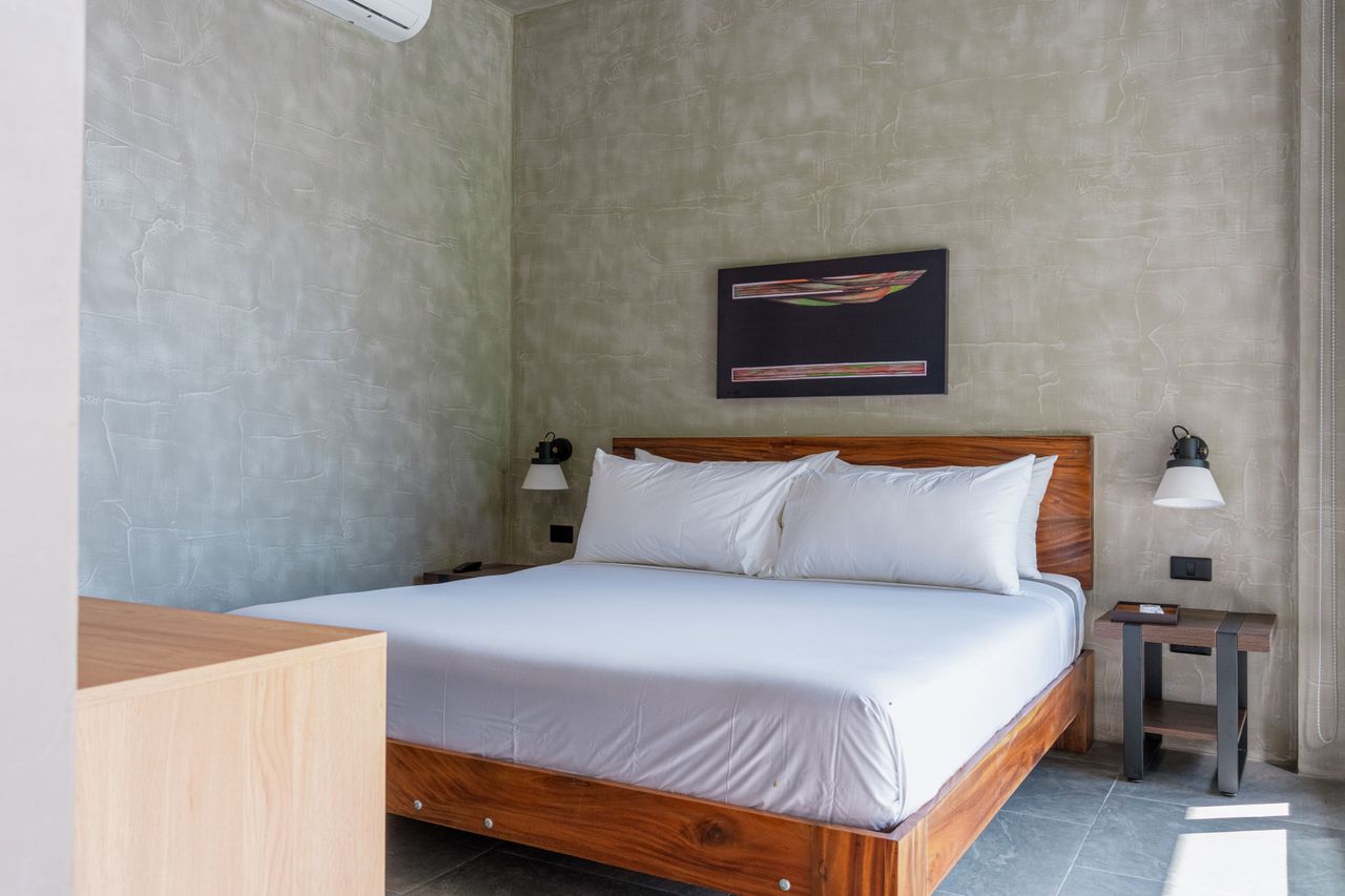 A king bed with abstract artwork and a dresser in a private Horizon bedroom