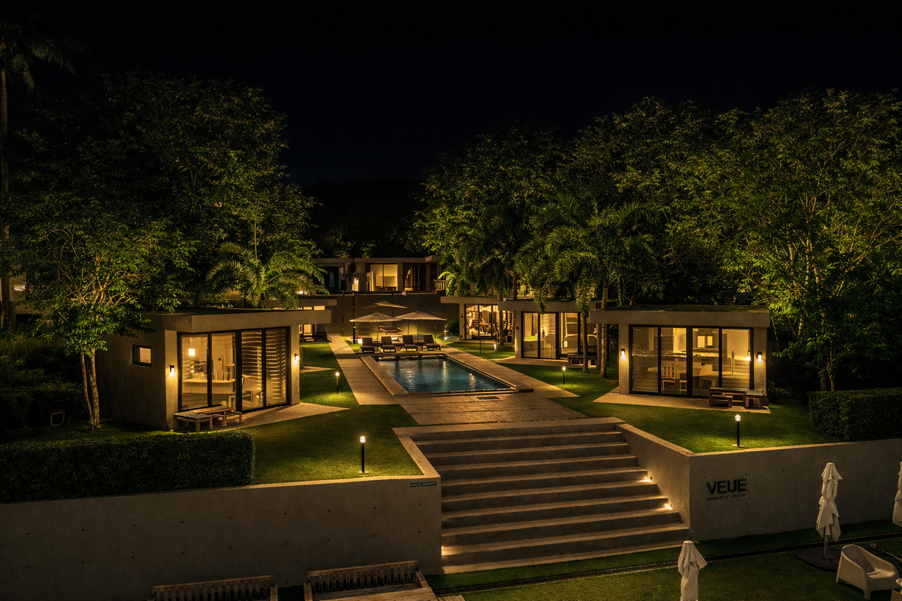Aerial view of Veue Beach Cabins at night with the pool lit
