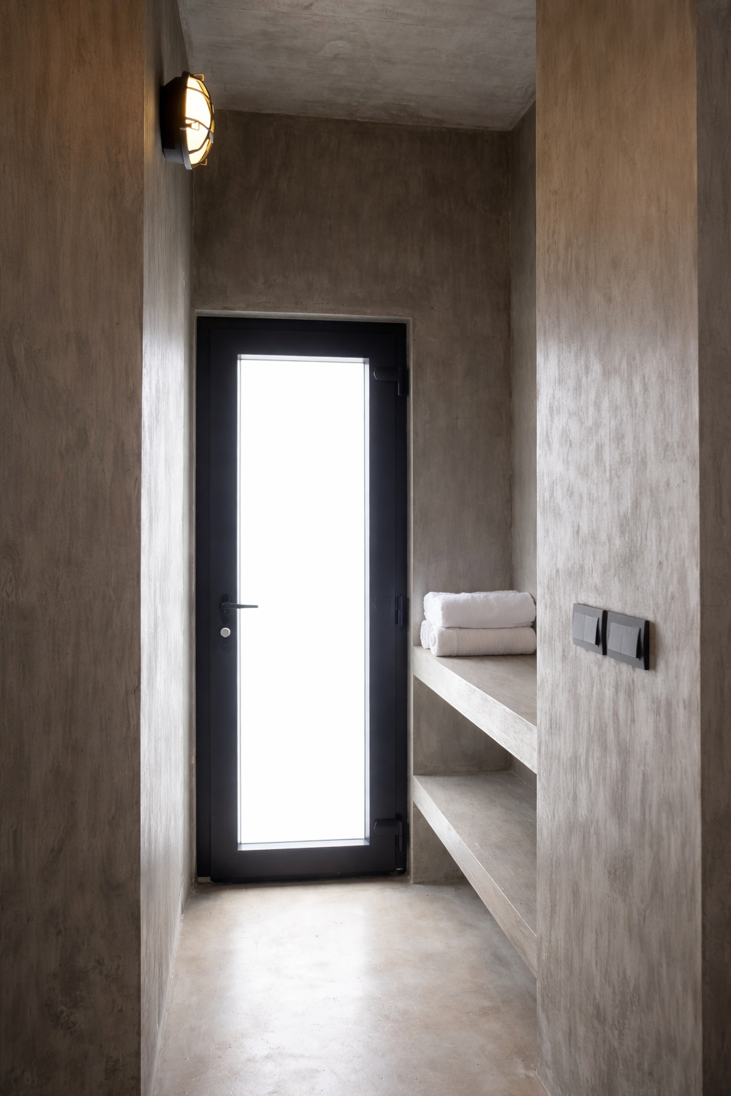 A cabin entry with built-in shelving and stacked towel sets
