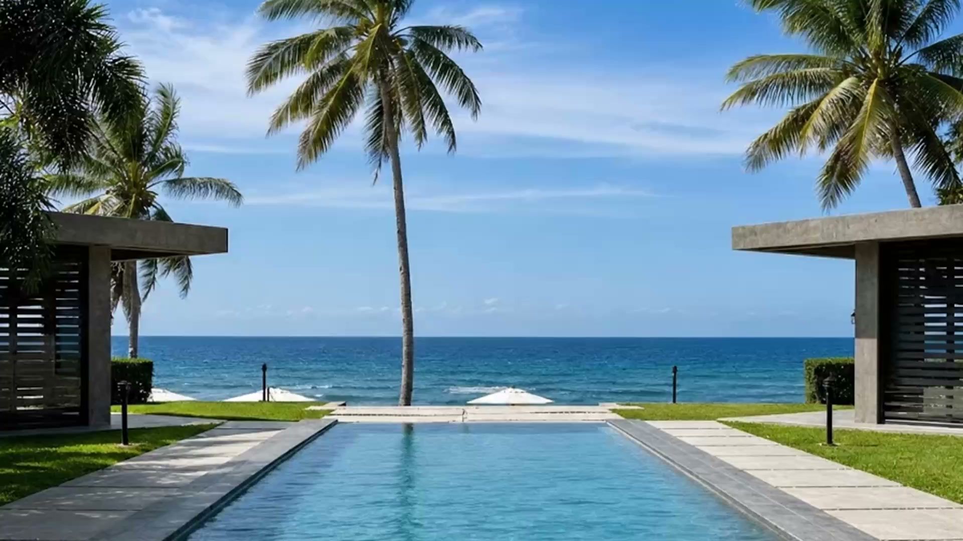 Veue Beach Cabins — an infinity pool framed by palms, looking west across the West Philippine Sea at Patar White Beach, Bolinao