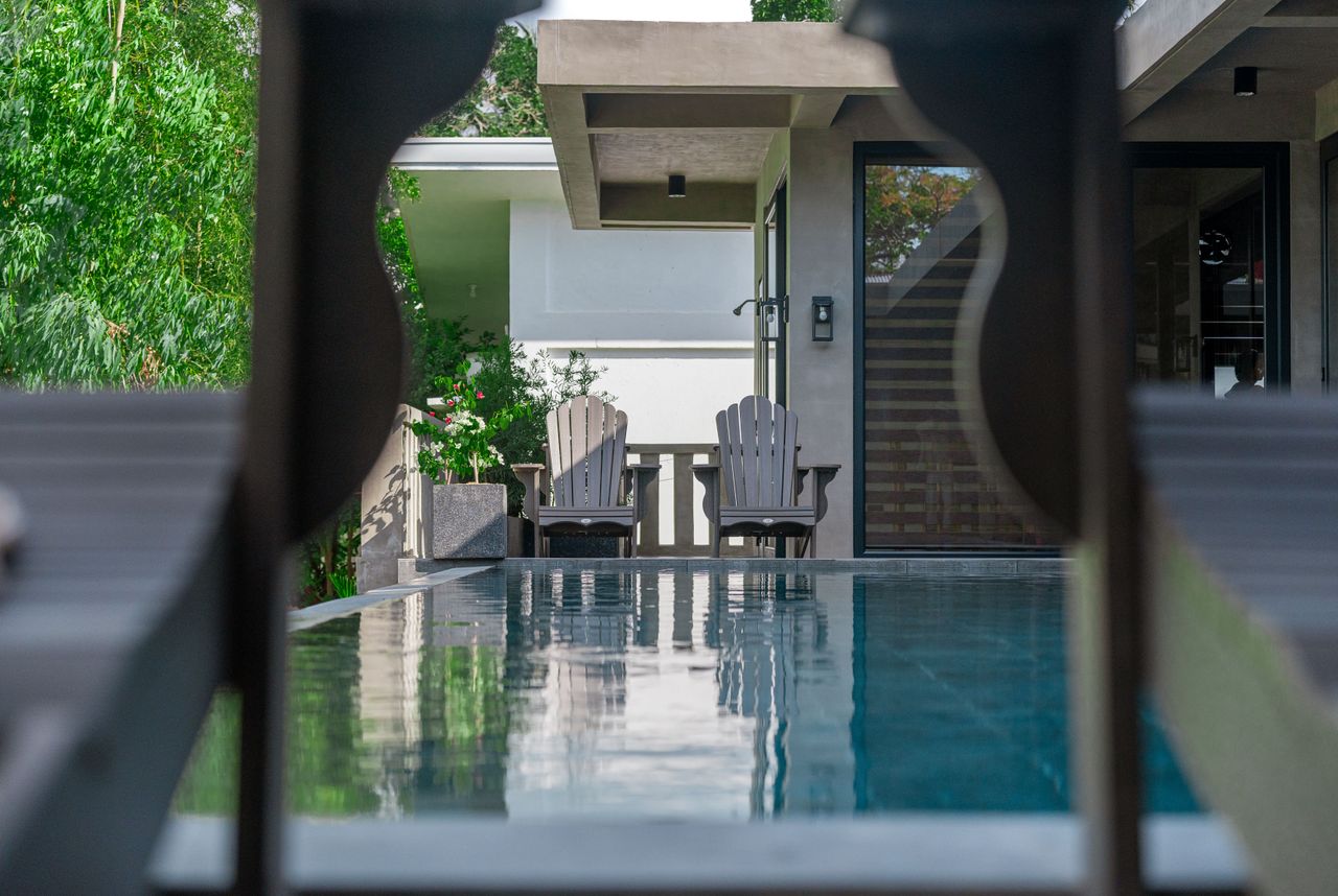 Adirondack chairs by the Horizon infinity pool framed through a chair back
