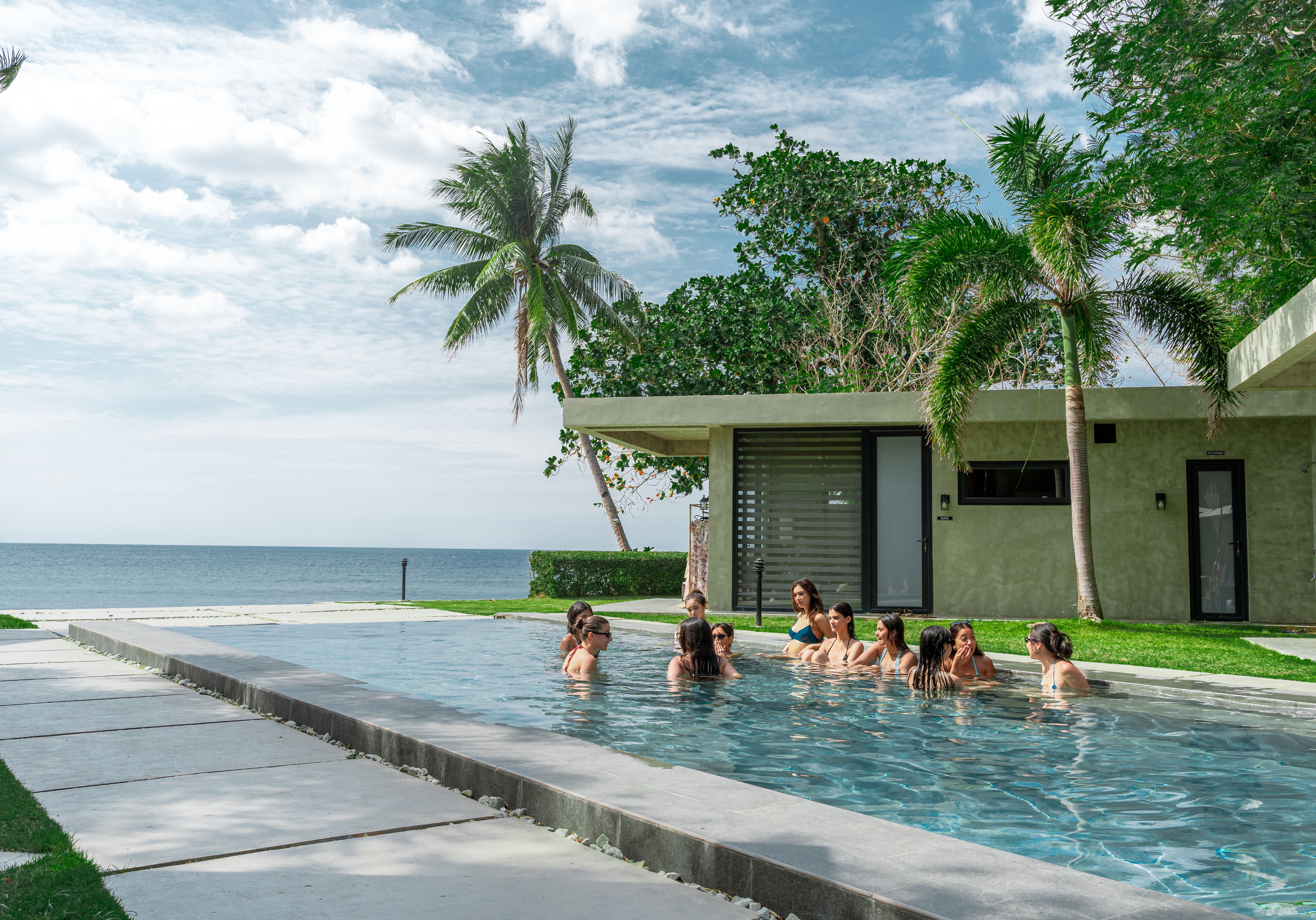 Guests relaxing on the underwater bench in the pool at Veue