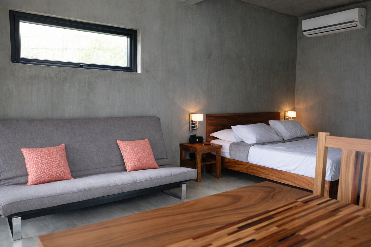 Inside a 50 sqm Shoreline cabin with a king bed and a convertible sofa bed