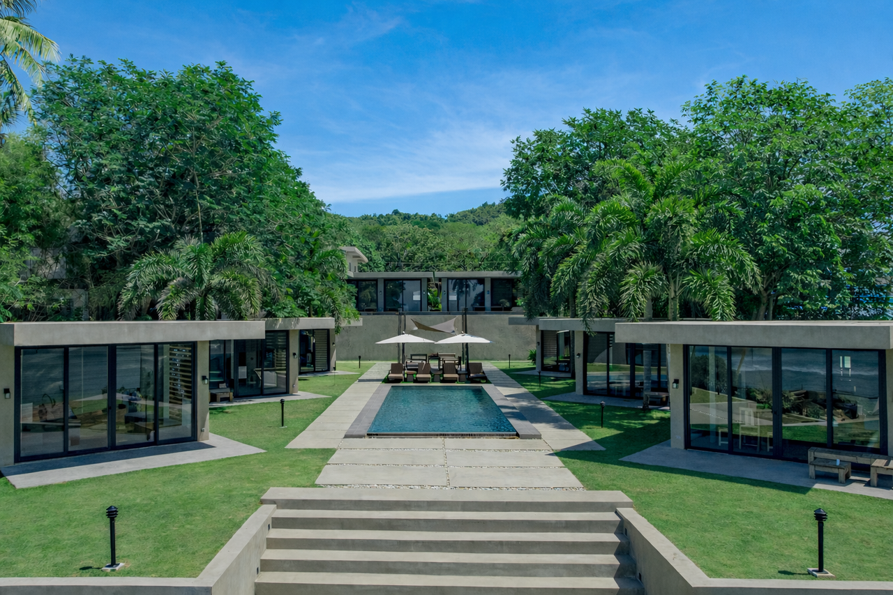 Symmetrical view down the center of Veue, pool and cabins mirrored to the sea