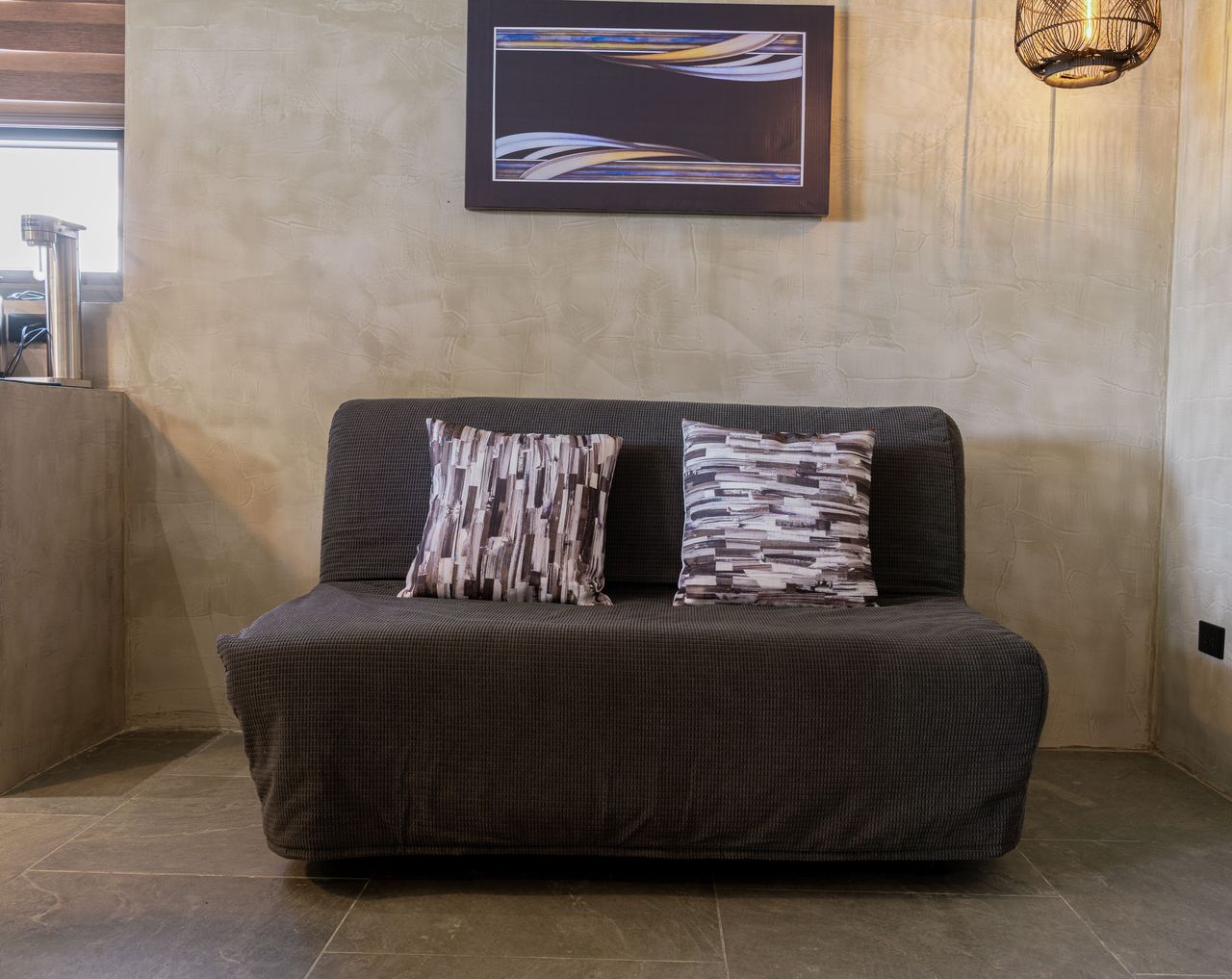 A charcoal sofa bed that folds out for extra sleeping in a Horizon cabin
