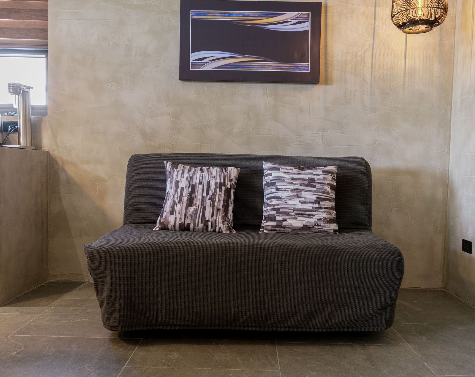 A charcoal sofa bed that folds out for extra sleeping in a Horizon cabin