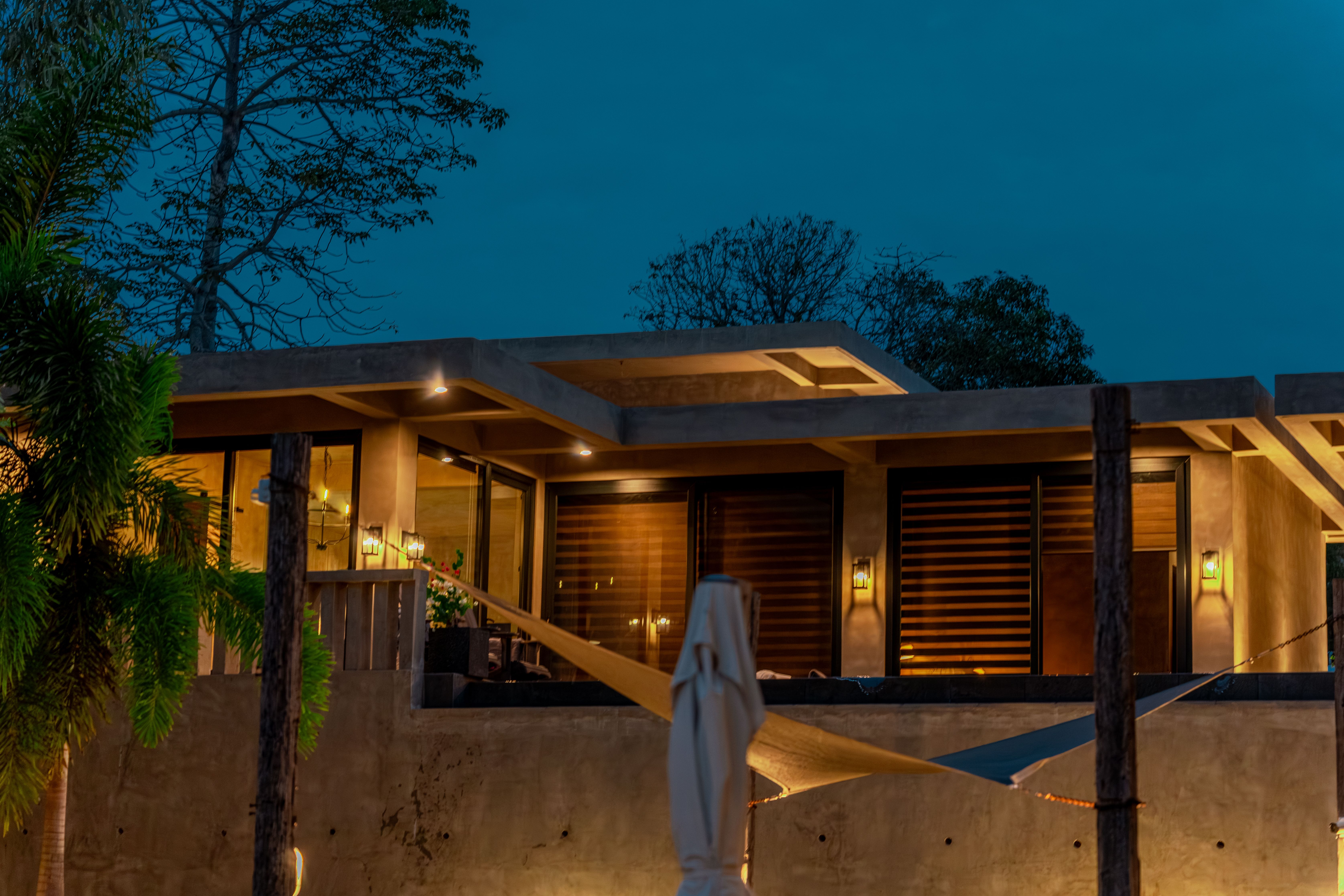 An elevated Horizon cabin glowing at dusk, set apart for privacy