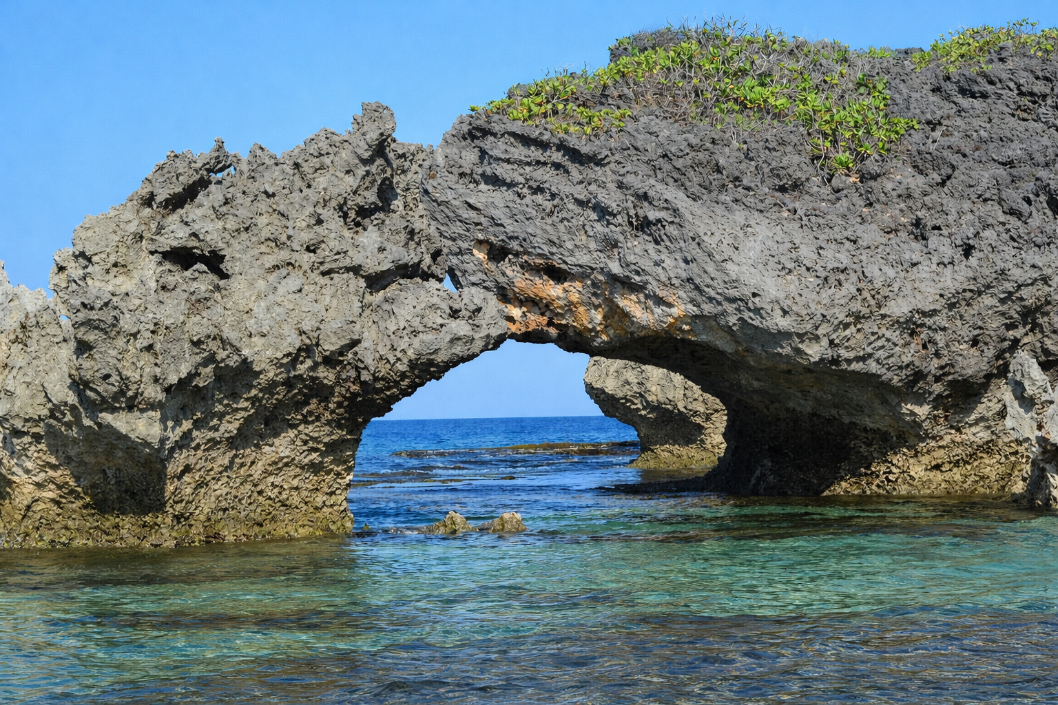 Limestone rock formations exposed at low tide along Patar Beach, with dramatic shapes left behind by the retreating sea.