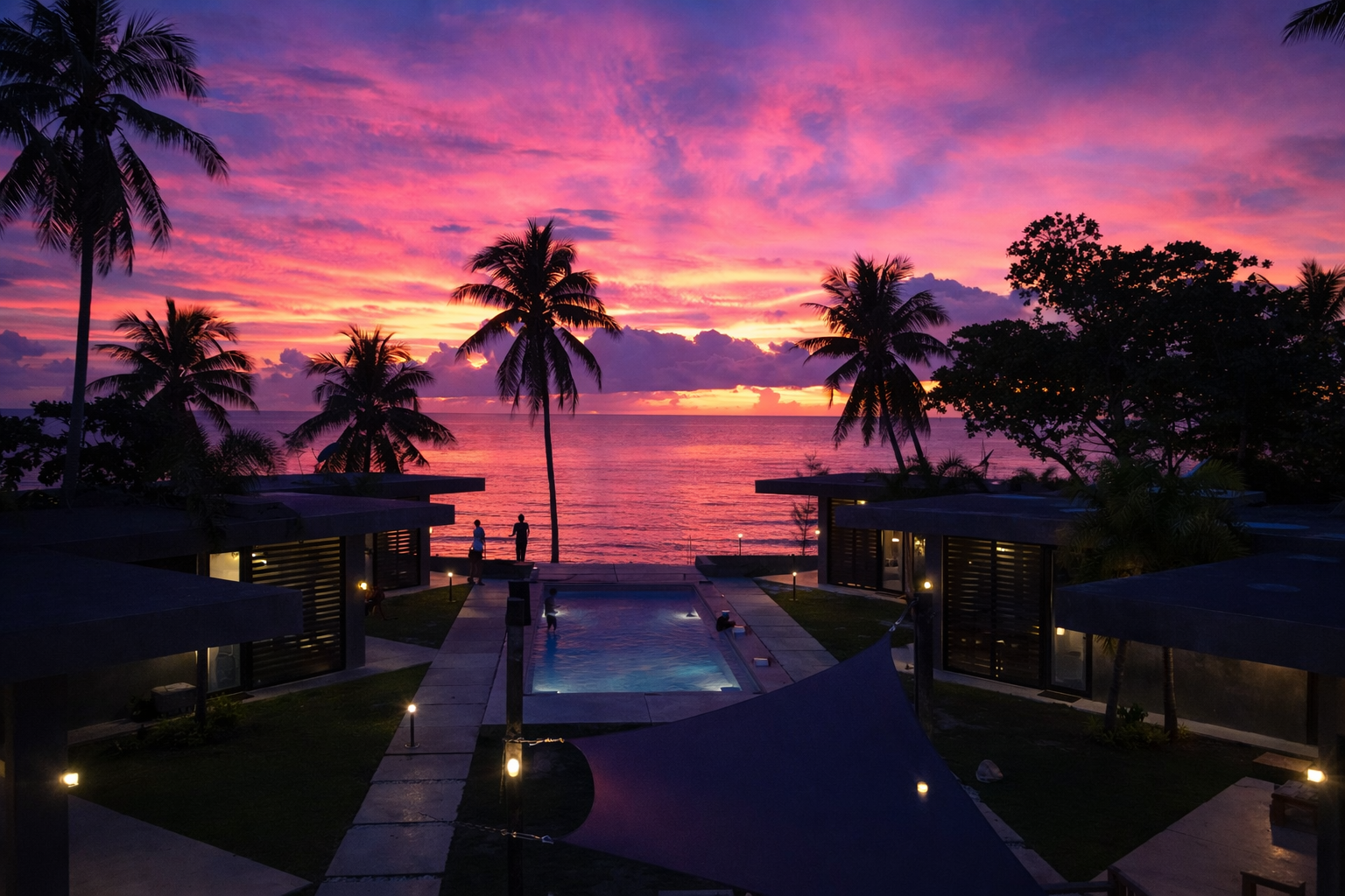 A wide sunset over the West Philippine Sea seen from the Patar shoreline, the sky in long bands of pink and amber.